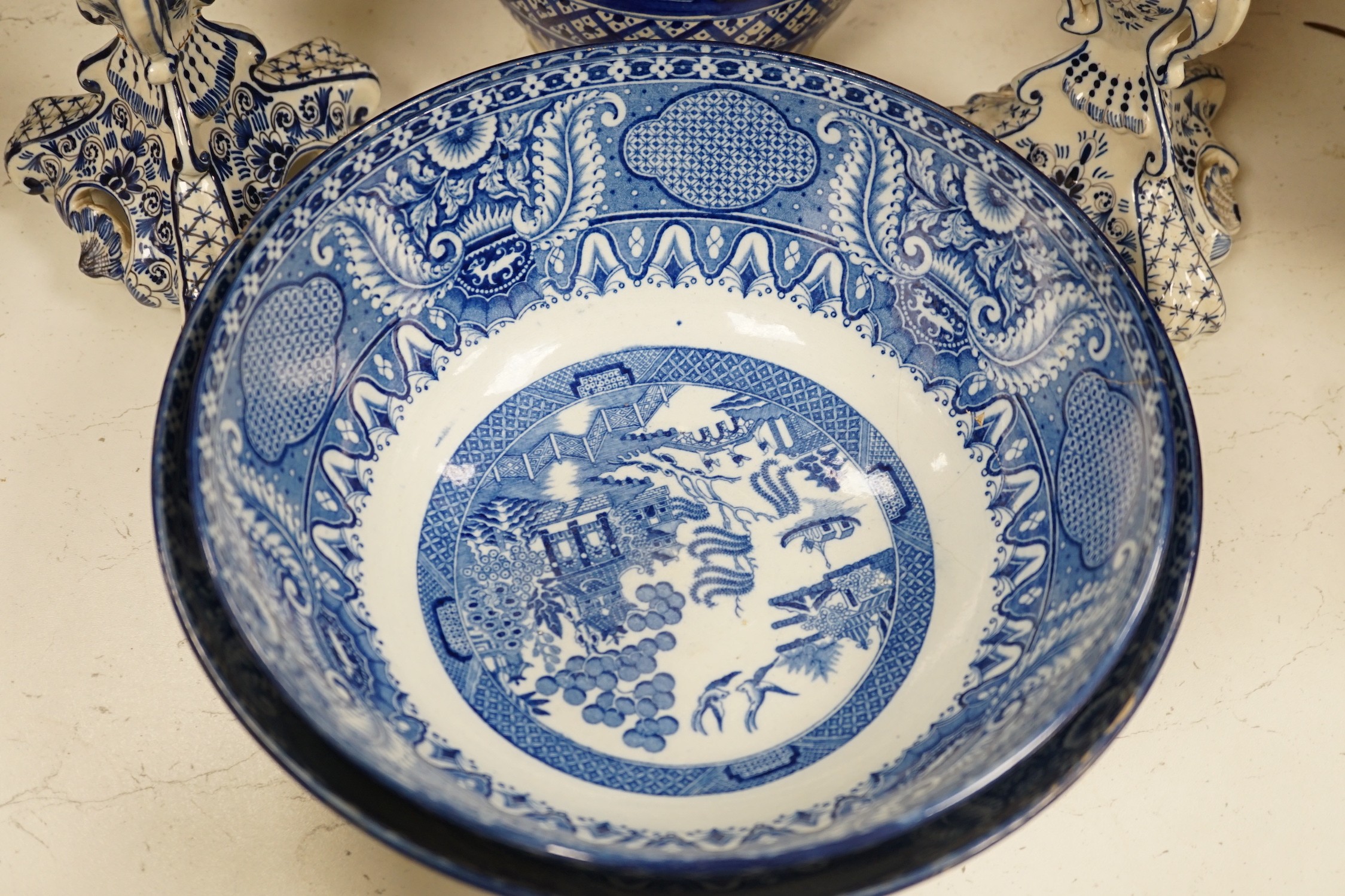 A pair of Delft blue and white candlesticks together with an 18th century Delft bowl, a Moroccan pottery jar with cover, and two pearlware bowls